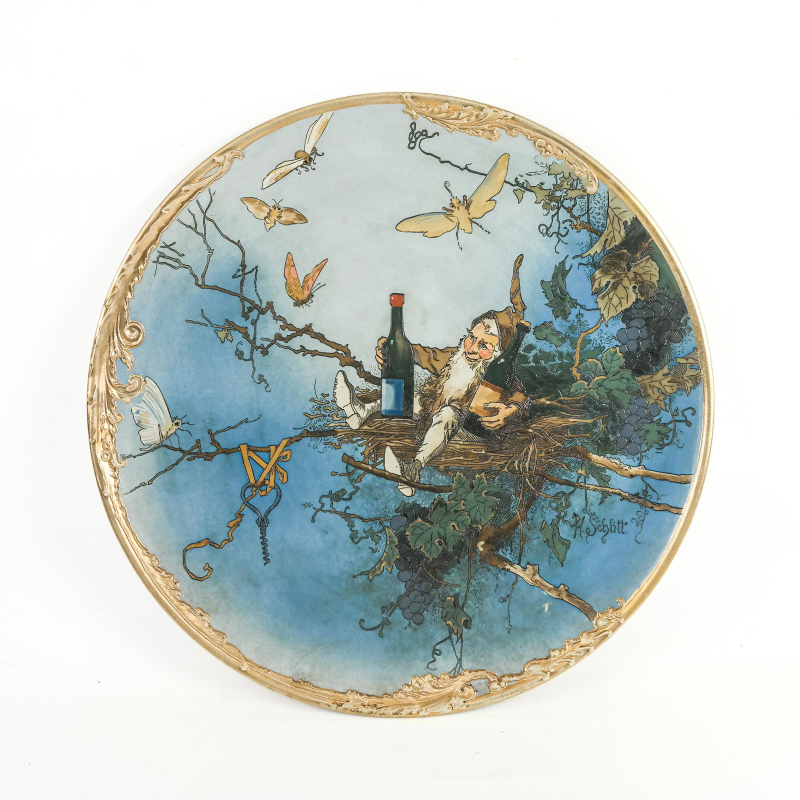 Large Meitlach Villeroy & Boch Charger: Large Meitlach Villeroy & Boch charger, early 20th century, painted with an elf seated in a nest with bottles, signed "H. Schlitt" lower right, marked verso. [16" Diam.]. Residue, marks, wear and scuf