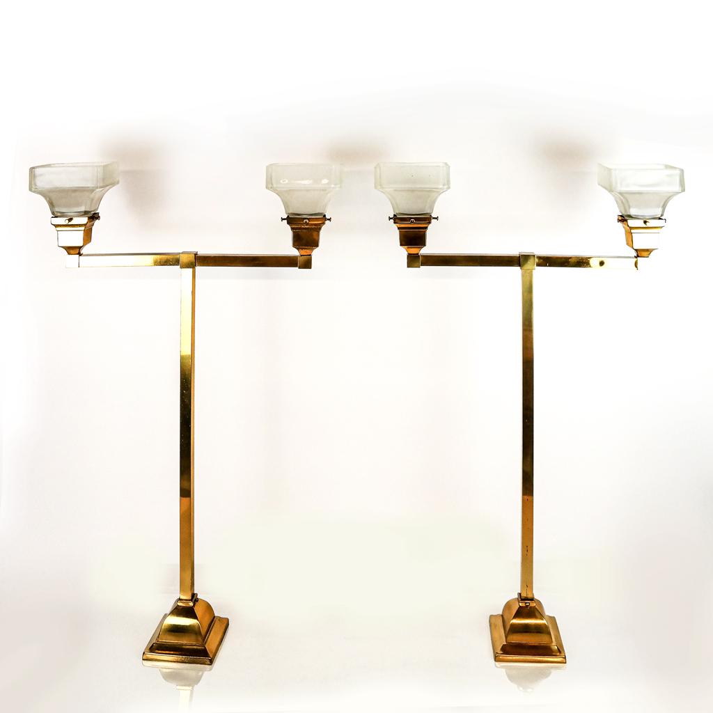 Pair of Brass Pendant Fixtures: Pair of pendant brass fixtures with glass shades, late 20th century, with long drop and simple glass shades. [32 1/2" H x 20" W x 6" D]. In good condition.