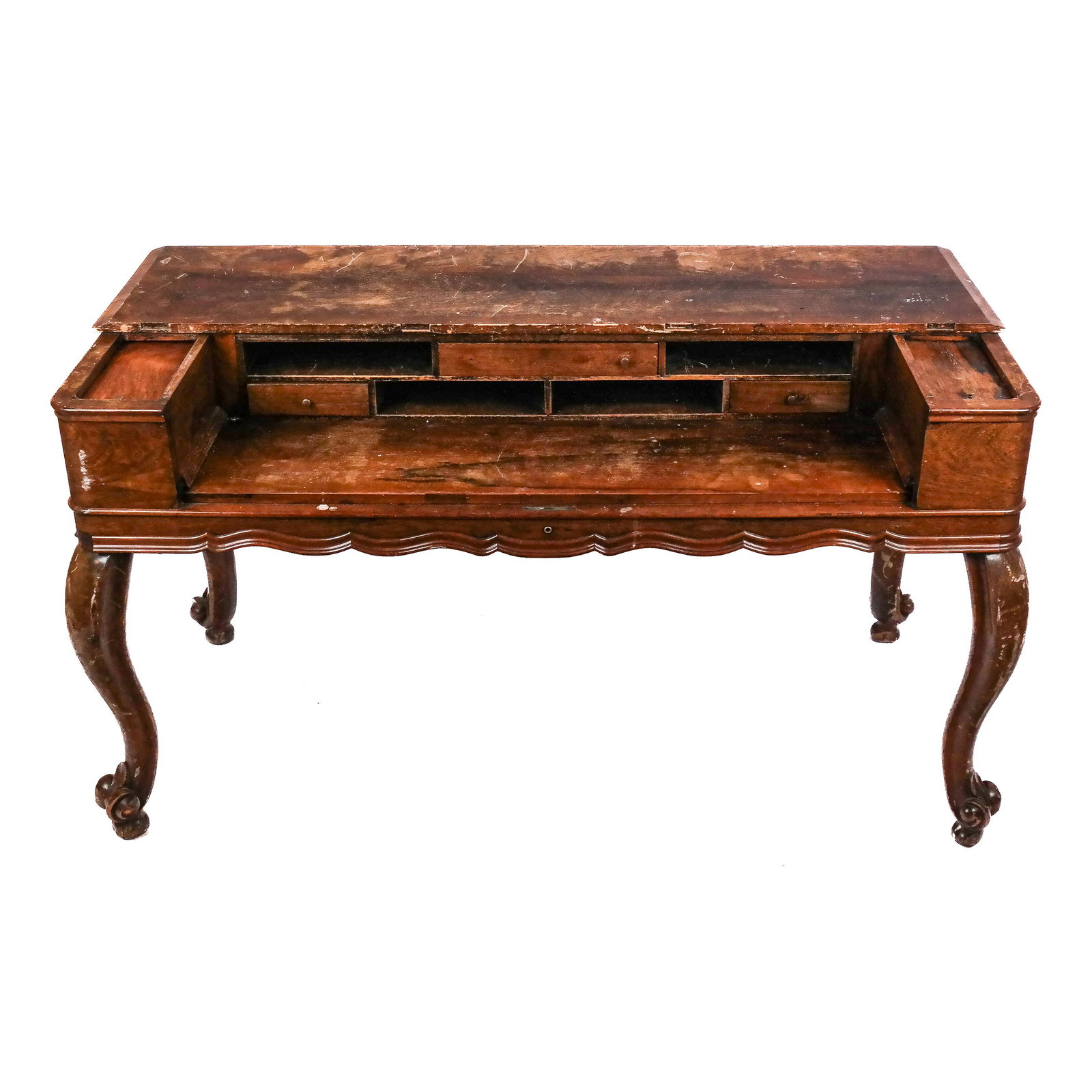 Victorian Carved Desk: Late 19th century Victorian carved desk, possibly converted from a spinet piano, with side compartments, raised on scrolling cabriole legs. [33 1/4" H x 58" W x 28" D]. Fading, stains, marks, scuffs a
