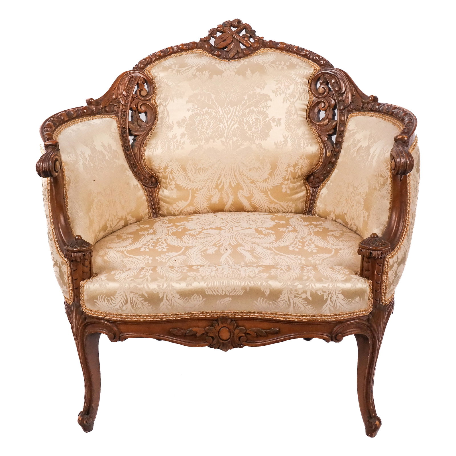 Louis XV-Style Bergere en Cabriolet: Louis XV-style bergere en cabriolet, 20th century, the armchair centered with carved crest with a musical trophy and scrolling details. [33 1/2" H x 34" W x 28" D]. Lacking seat cushion; wear to carvi