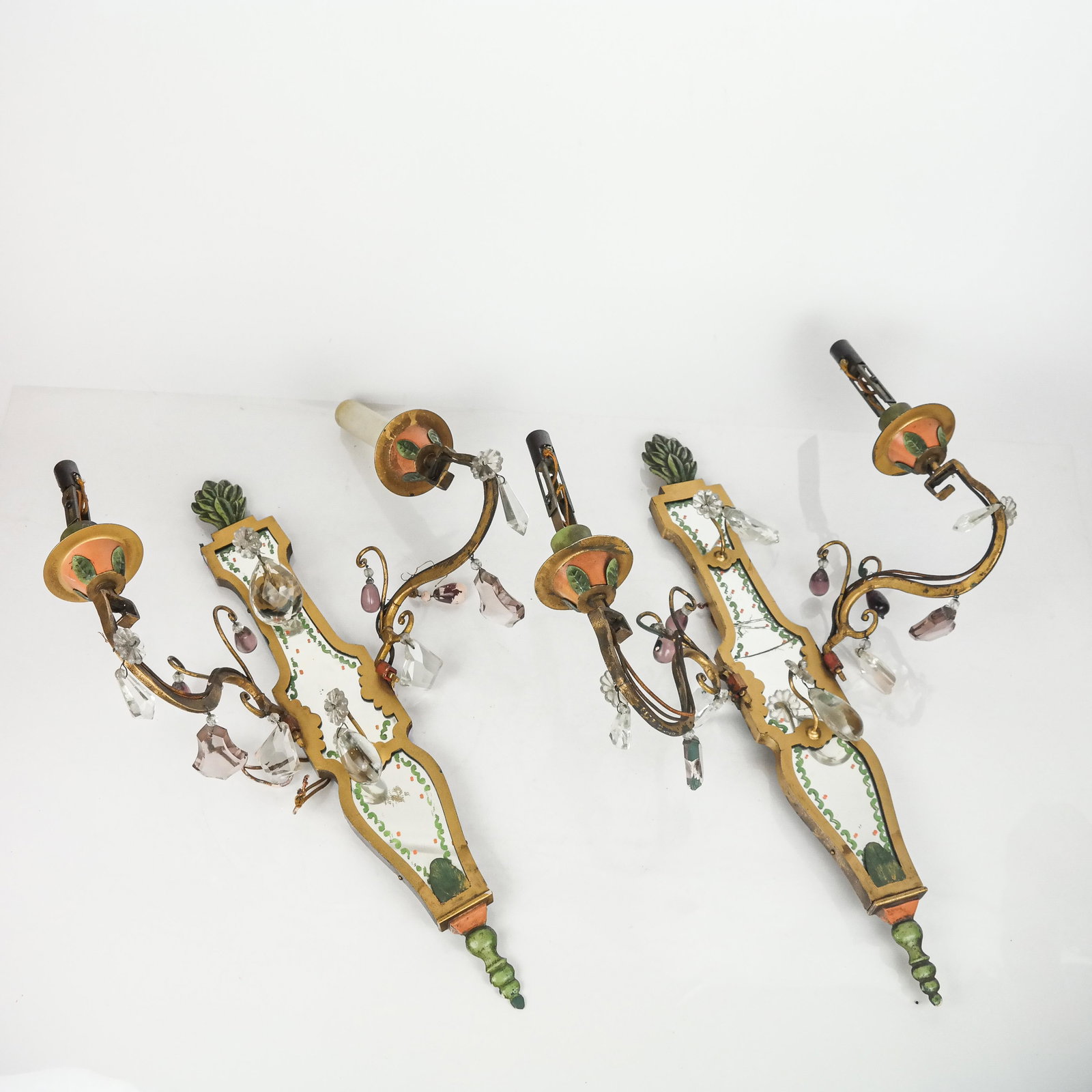 Pair of Metal & Glass Two-Light Sconces: Pair of gilt metal and glass two-light sconces, with enameled details and amethyst glass and clear drops, with later conversion to electricity. [20" H x 13 1/2" W x 8" D]. One back mirror cracked, oth