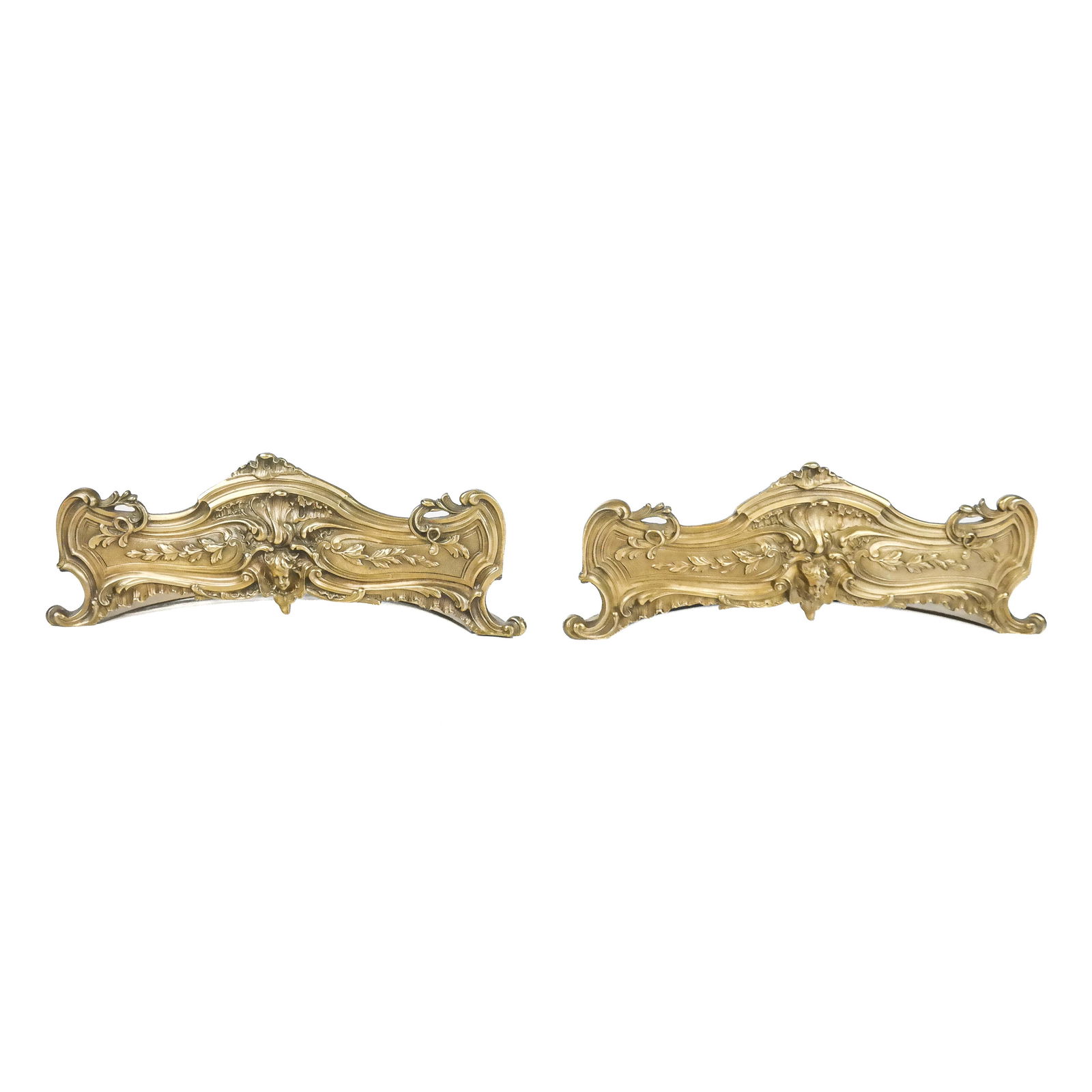 Pair of French-Style Brass Bookends: Pair of French Rococo0style brass bookends with foliate panels in asymmetric curved design with "D" section supports and cherub head decoration. [4 3/4" H x 11 1/2" W x 4" D]. One join with wear, othe