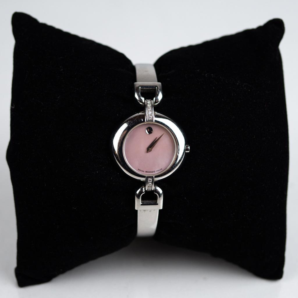 Movado "Vivo" Ladies Wristwatch: Movado "Vivo" ladies wristwatch with pink mother-of-pearl style face with diamond mounts in Art Deco style, in stainless steel with sapphire crystal.