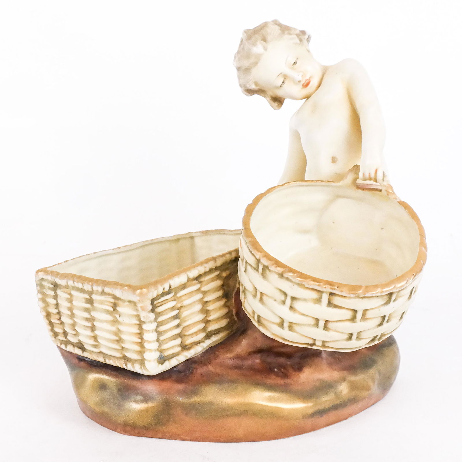 "Amphora" Austrian Figure of Child: An "Amphora" Austrian figure modeled as a child struggling with two baskets, marked and numbered. [8 1/2" H x 8 1/2" W x 6" D]. In good condition; no chips, cracks or repairs.