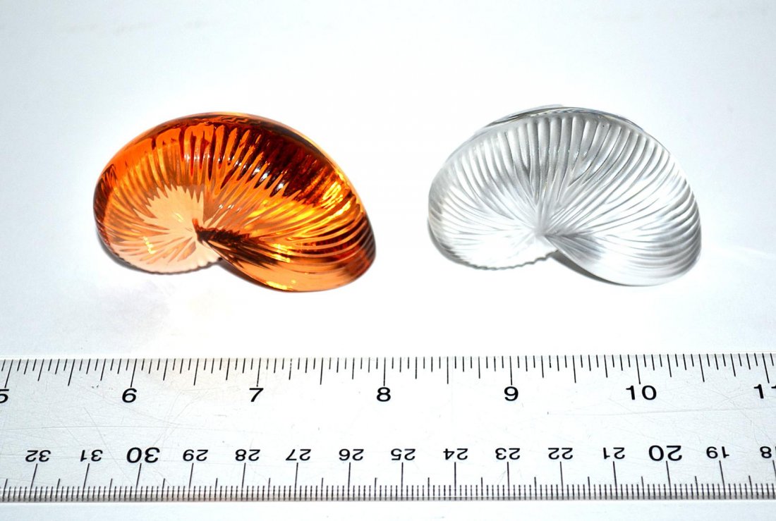 Pair of Baccarat Snail Paperweights: Pair of snail shaped paperweights. One amber, one clear, each signed "Baccarat". From the Estate of Arthur Laurents.
