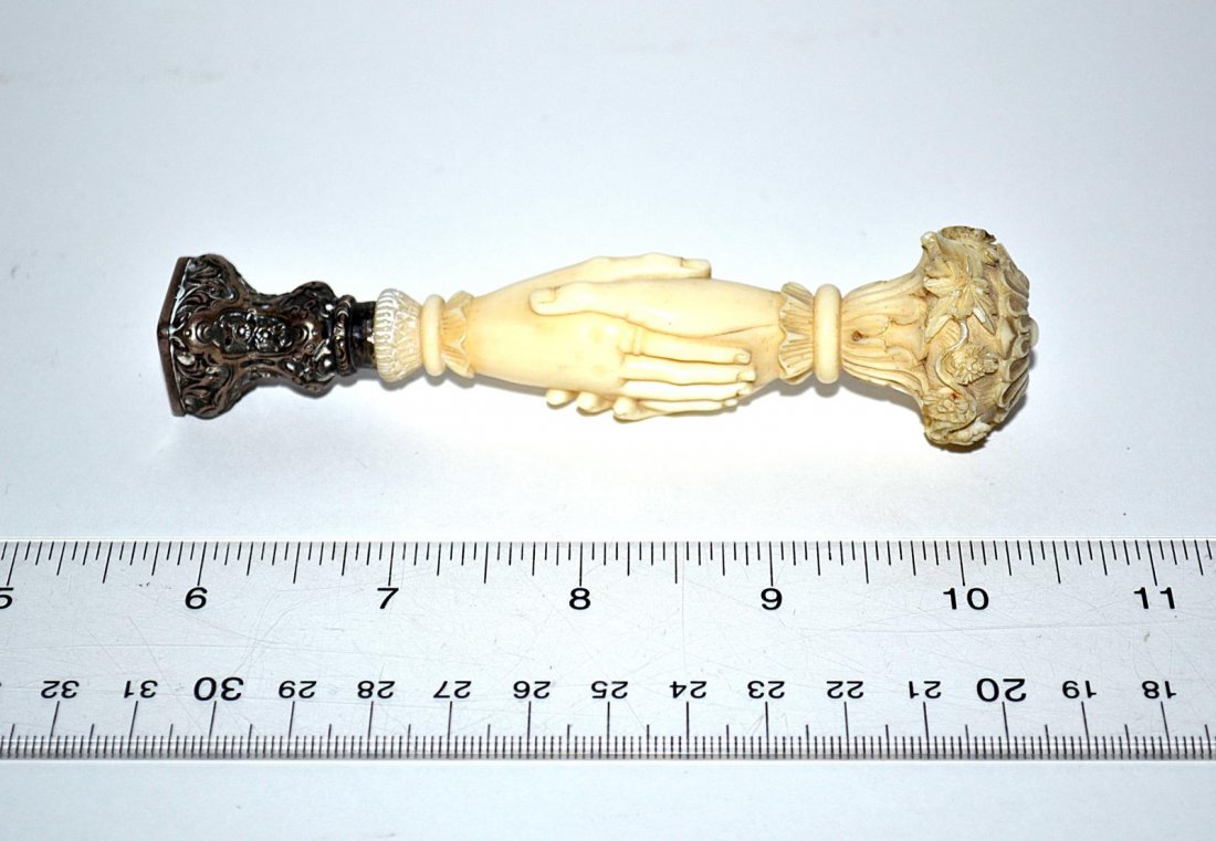 Ivory and Silver Stamp: An ivory and silver stamp depicting a handshake. Continental, 20th C. 5" L. Good condition. From the Estate of Arthur Laurents.