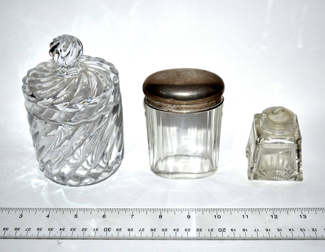 Group of Assorted Crystal and Glass Items: A group of assorted items, including a crystal and silver jar, a crystal powder jar, and an ink bottle. In good condition. From the Estate of Arthur Laurents.