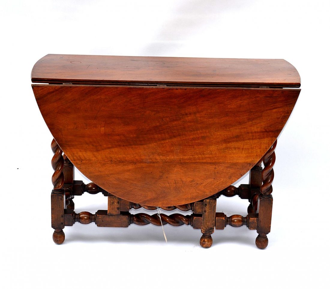 Walnut Drop-Leaf Table with Barley Twist Legs: A walnut drop-leaf table with barley twist legs. English, 20th C. Good condition. From the Estate of Arthur Laurents. 59.5"W (open) x 44.5"D x 30.5"H leafs closed: 19.5" W
