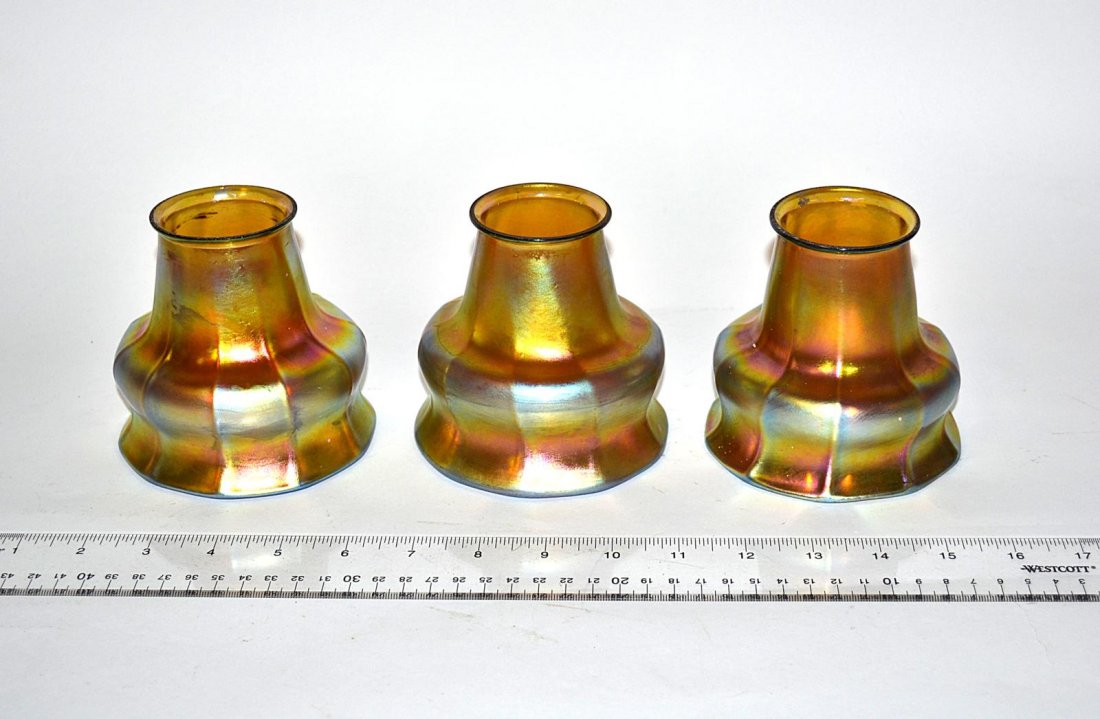 Set of Three Steuben Glass Shades: Set of three shades with vertical ribs tapering to base. Unsigned. 2 3/8" Dia [at base] 4 1/4" Dia [at mouth] and 4" H. All in very good condition.
