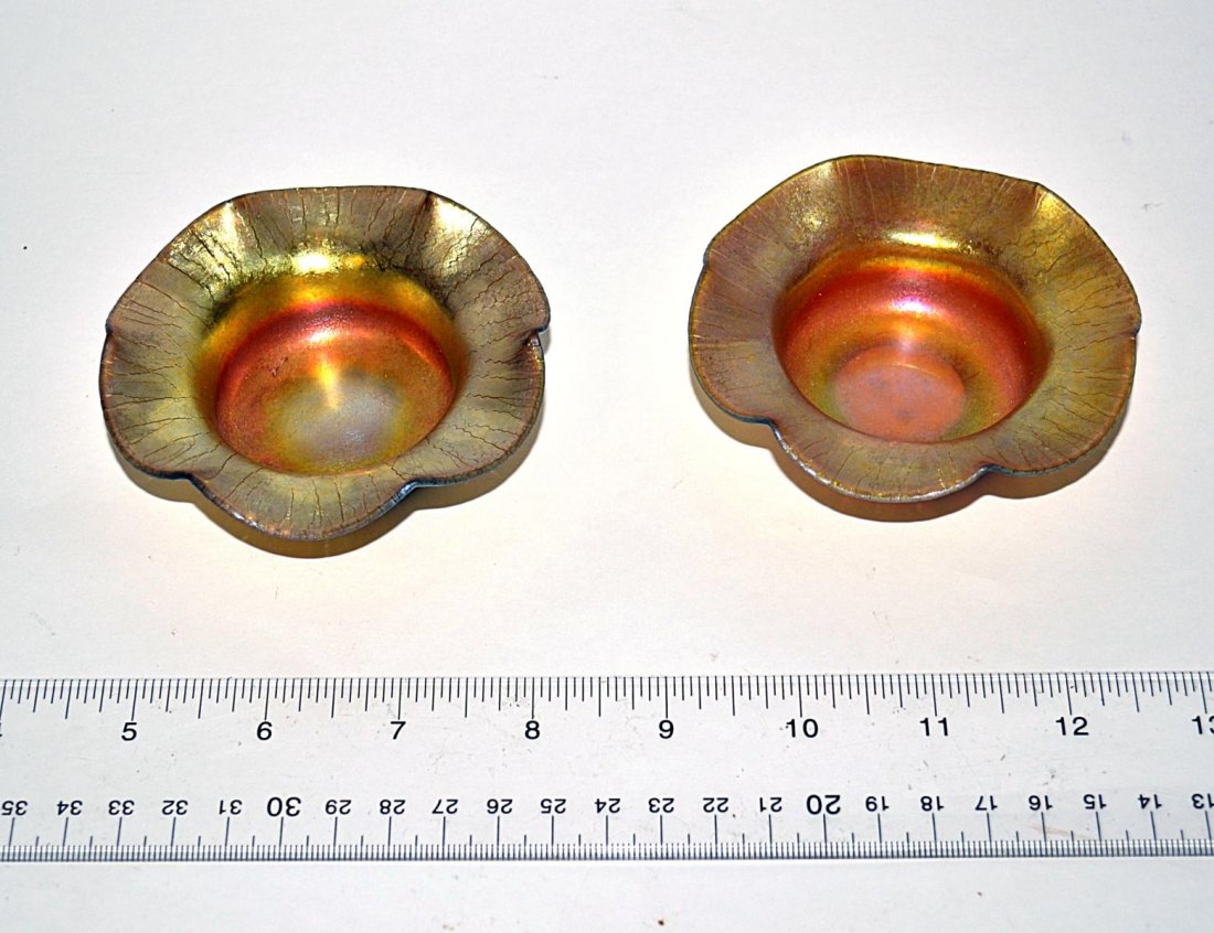 Pair of Aurene Glass Salt Cellars: Pair of flower-form salts with undulating scalloped rims. Each bear etched "Aurene" inscription on bottom with one marked "138" and the other "198". Both 3 5/8" Dia. x 1 1/8" H. In very good condition