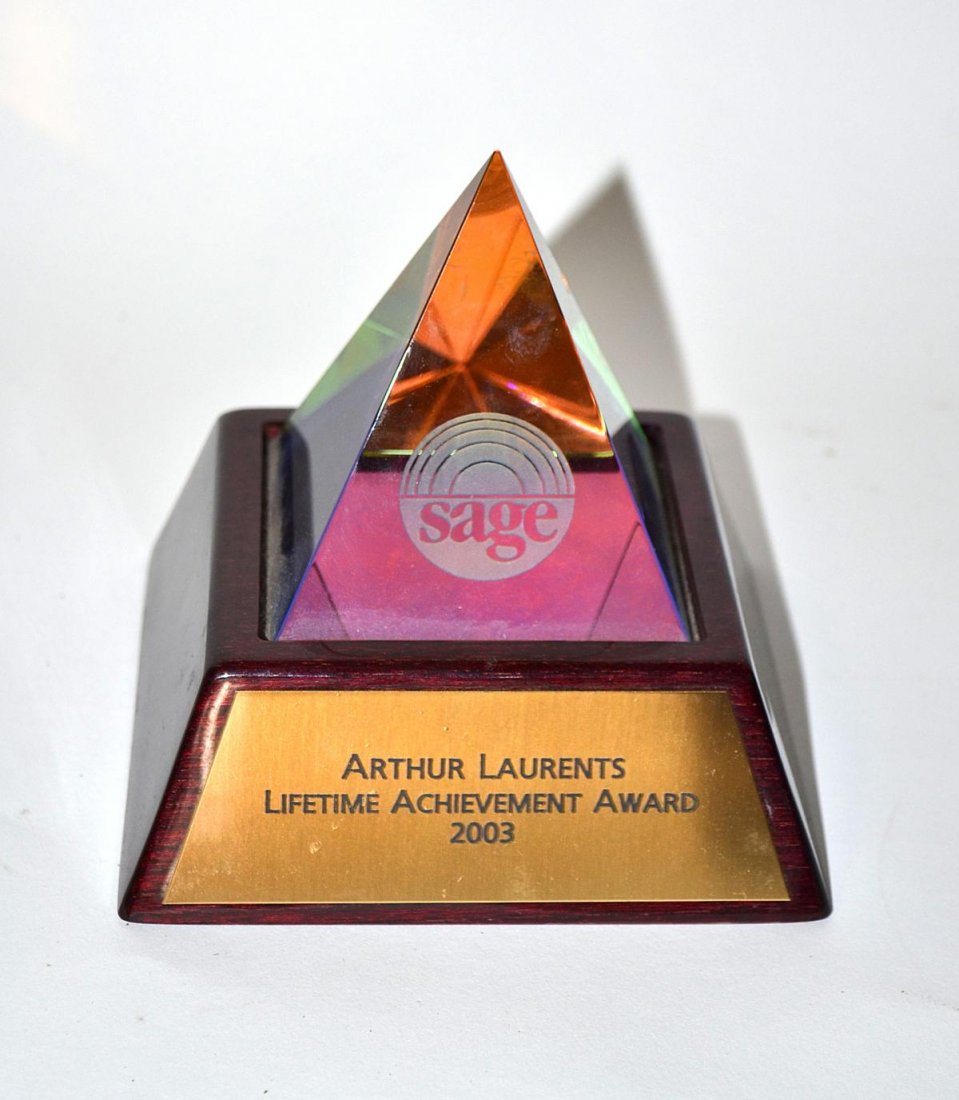 Arthur Laurents' Sage Award: Tinted crystal pyramid-form award on a conforming mahogany base. Bears an engraved brass plaque with inscription "Arthur Laurents / Lifetime Achievement Award / 2003". 5" x 5" x 4 3/4" H. In very good