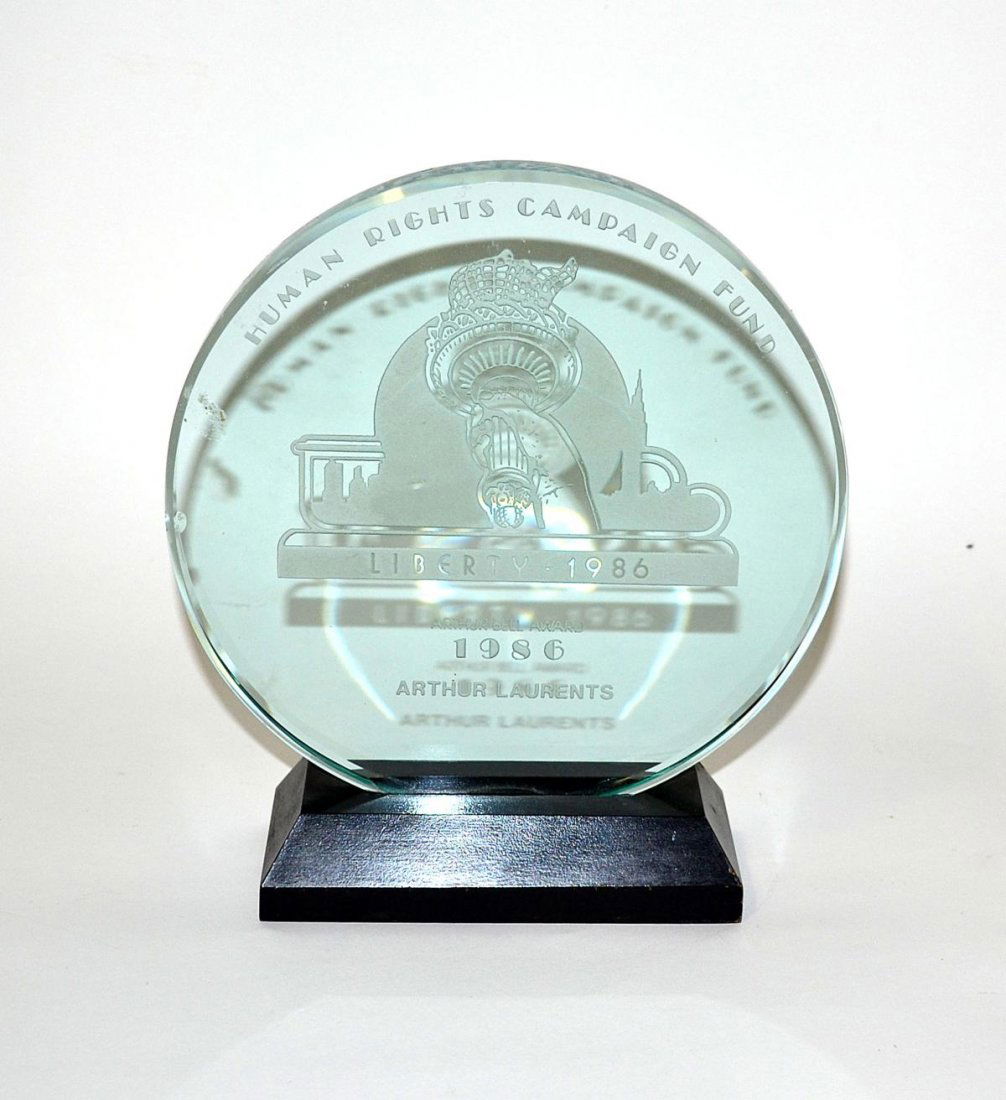 Arthur Laurents' Human Rights Campaign Fund Award: Circular cut glass award on an ebonized base. Bears etched inscription: "Human Rights Campaign Fund / Liberty 1986 / Arthur Bell Award...Arthur Laurents." Bears one small clam-shell chip on back left