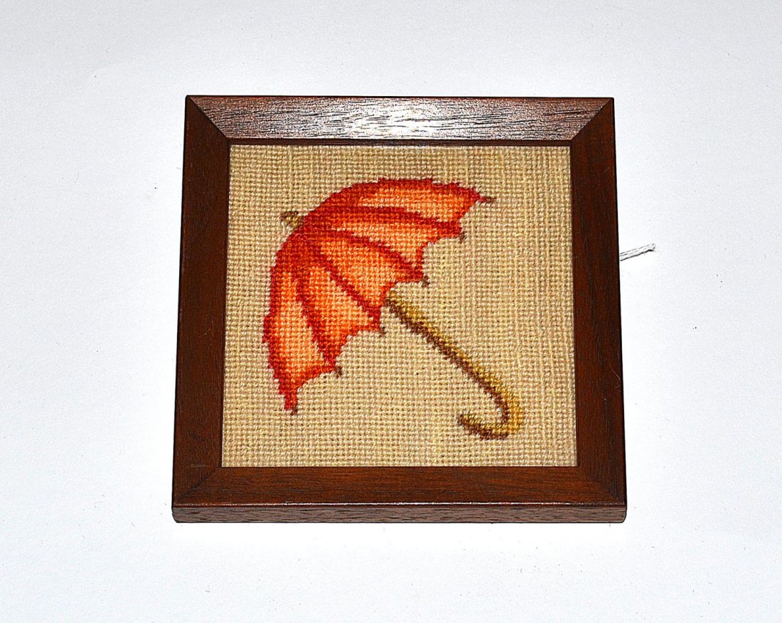 "Hallelujah, Baby!" Needlepoint Illustration: 3 3/4" sq depiction of an orange umbrella. Mounted and contained under glass in a 4 3/4" sq mahogany frame. In excellent condition. From the Estate of Arthur Laurents.