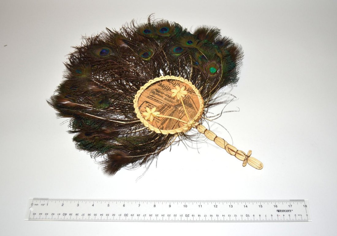 Vintage Peacock Feather Fan: Nepalese hand fan composed of peacock feathers with bound natural fiber handle. As is, some feathers worn. 18 1/2" H x 14" W.