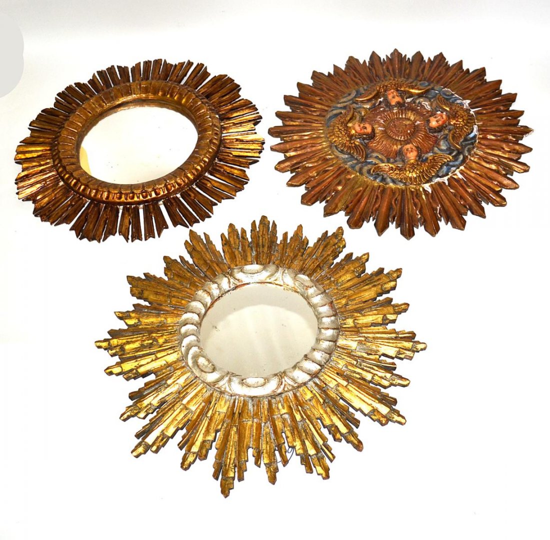 Three Decorated Appliques: One gilt carved round cherub relief together with two gilt round mirrors. All sunburst form. 19 1/2" x 20 1/2".