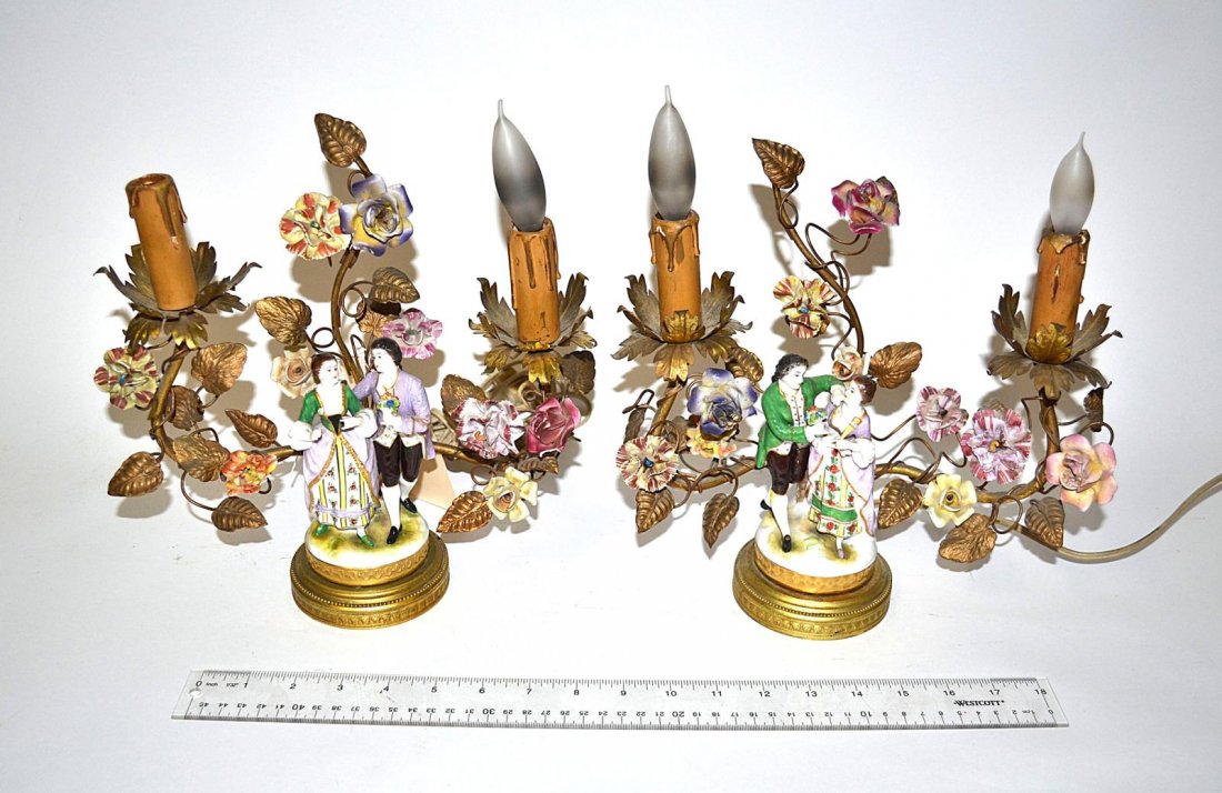 Pair of Figural Lamps: Each feature a "courting" porcelain figural group among gilt tole and porcelain flower elements. Both bear two candelabra base lights. Some chips and losses.