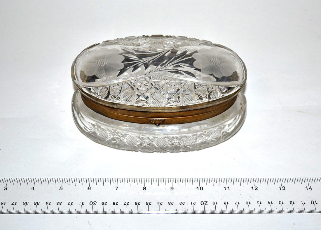 Cut Crystal & Bronze Jewelry Box: Oblong cut crystal box with rosette, leafy spray and geometric designs bearing bronze fittings. 7" W x 4 1/4" D x 3 1/4" H. In good condition.