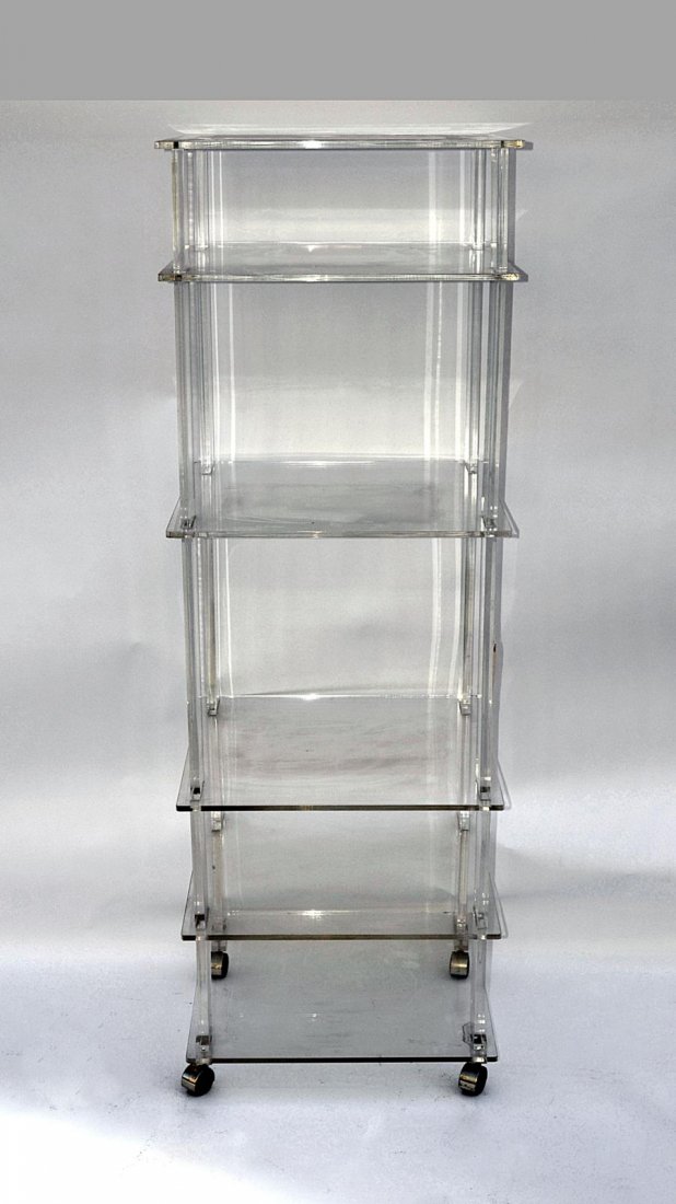 Large Lucite Étagère: Five tier étagère on castor feet. 24" x 24" x 72" H. Minor scratches and scuffs, otherwise good condition.