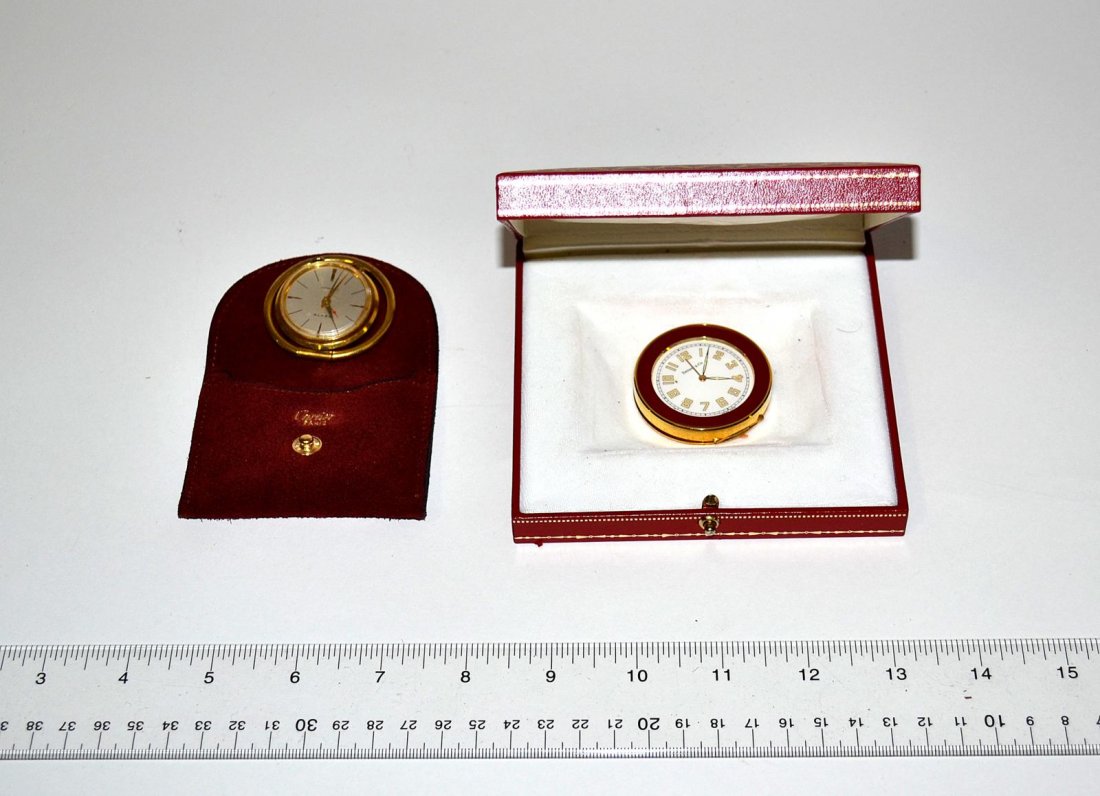 Two Tiffany Clocks: One red and brass, the other with a hinged ring. From the estate of Arthur Laurents. 1 3/4" Dia [approx].