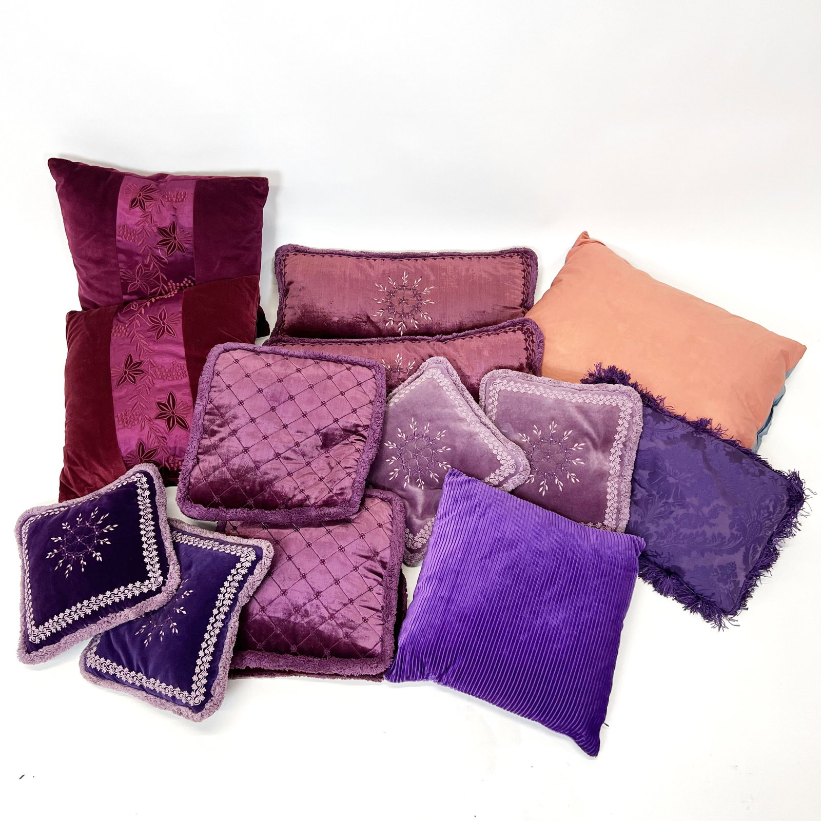 Assorted Purple Pillows: Assorted pillows, including two pairs and others in purple, and pink and blue.