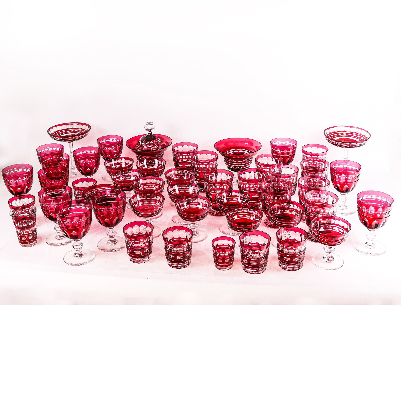 Red Flashed Crystal Bohemian Glassware Set: Red flashed crystal Bohemian glassware set, comprising: 12 large wine glasses, 12 champagne coupes, 10 water glasses, 6 tumblers, 2 small (shot) tumblers, 2 covered sweet dishes and 2 open tazzas. 20t
