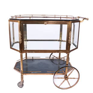 Vintage Impressive Bronze & Glass Paneled Bar Cart: An impressive bronze bar cart in hexagonal-form having beveled glass panels, the main bar unit with drop front door, with a removable tray top having black lacquer and brass molded frame with gallery