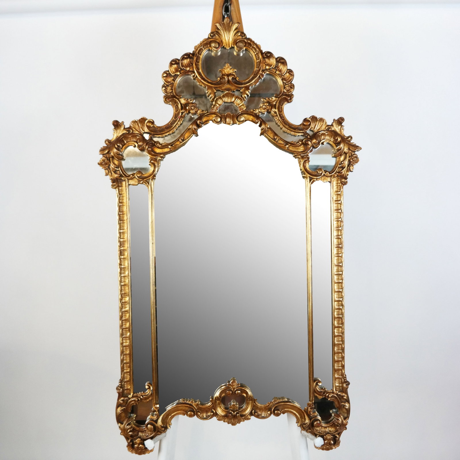 Giltwood Carved Louis XV Rococo-Style Mirror: All around ornately giltwood carved Louis XV Rococo-style pier mirror having one mirror behind five carved sections. [58" H x 31" W].