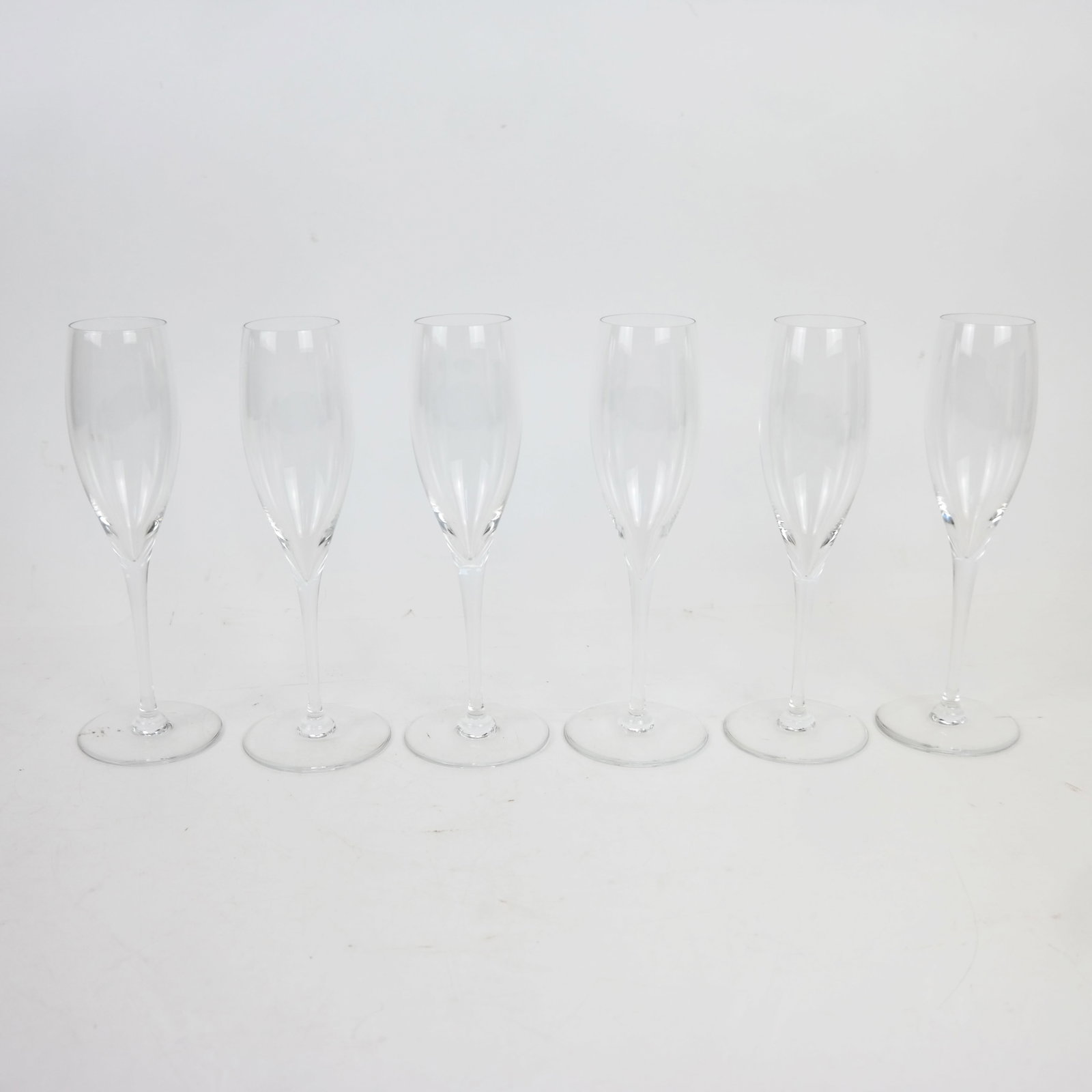 Six (6) Baccarat Champagne Stems: Six Baccarat champagne stems. [8 1/2" H].
