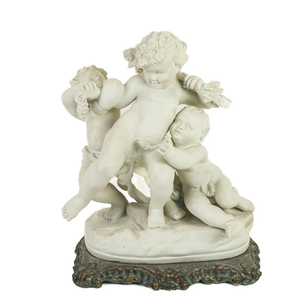 Rococo-Style Bacchanalian Figural Group: Rococo-style Bacchanalian figural group modeled as three putti frolicking with grapes and leaves, on a Rococo-style base. [Overall: 14 1/2" H x 12 1/2" W x 7 1/2" D]. Breaks to fingers; marks and wear
