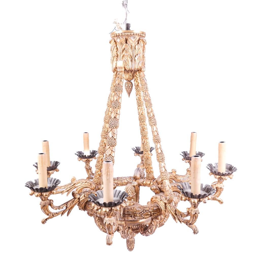 Large Neoclassical-Style Carved 8-Light Chandelier: Large Neoclassical-style carved giltwood eight-light chandelier, 20th century, overall with foliate and Bacchanalian grape motifs to the cage-form frame and upswept arms. [45" H x 42" Diam.]. Breaks a