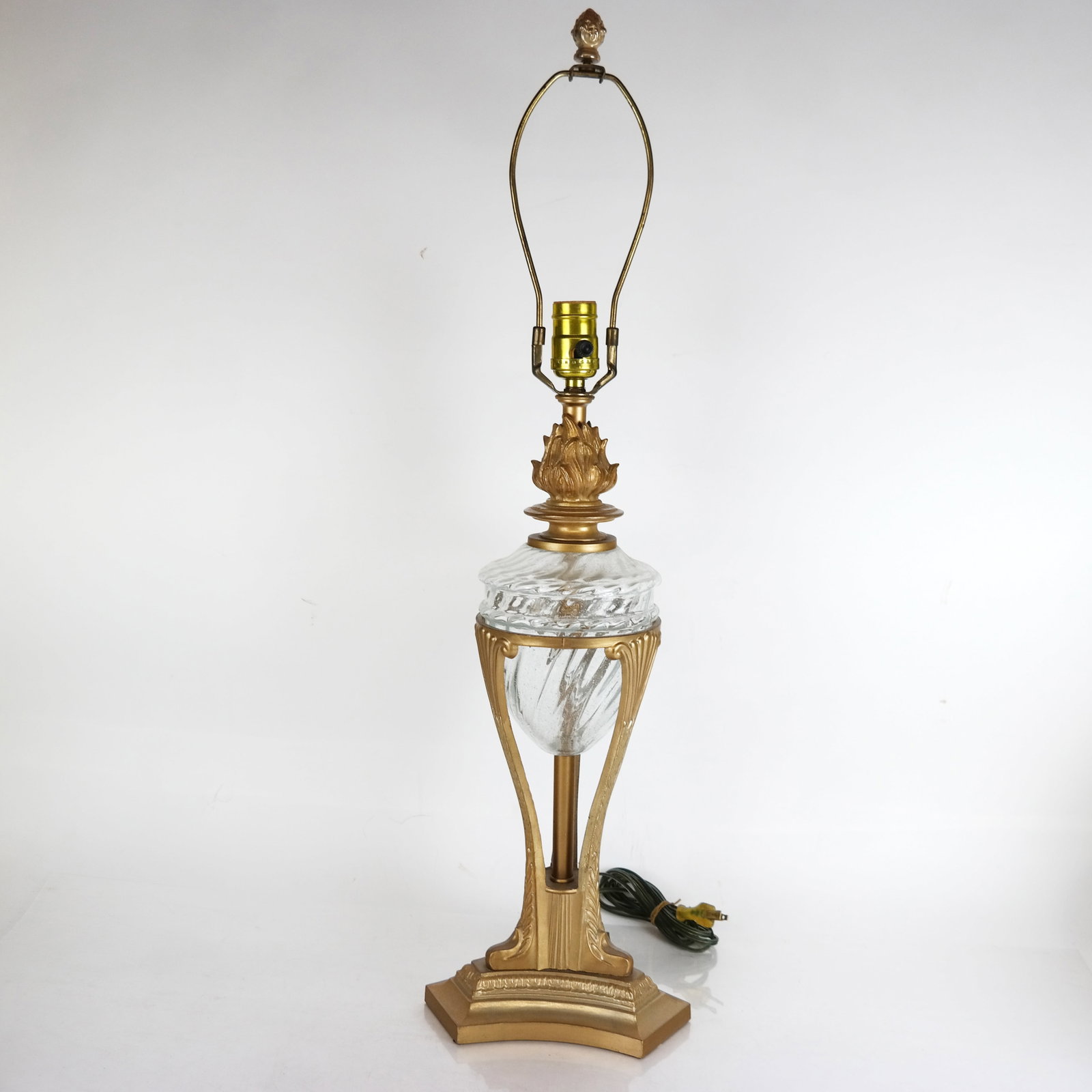 Neoclassical-Style Gilt Metal & Glass Table Lamp: Neoclassical-style gilt metal and glass table lamp, late 20th century, with fire detail above a swirled glass body. [30" H x 8 1/2" Diam.]. In overall good condition, with minor wear.