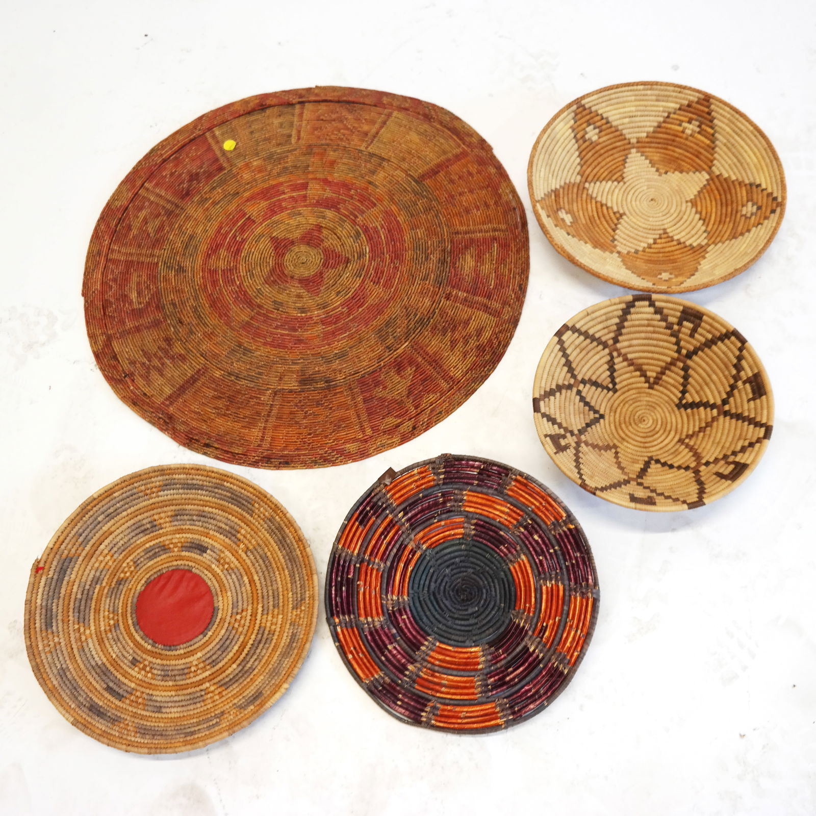 Five (5) Native American Woven Articles: Five Native American woven articles, comprising four bowls and one flat round table trivet. [Largest: 26" Diam.].