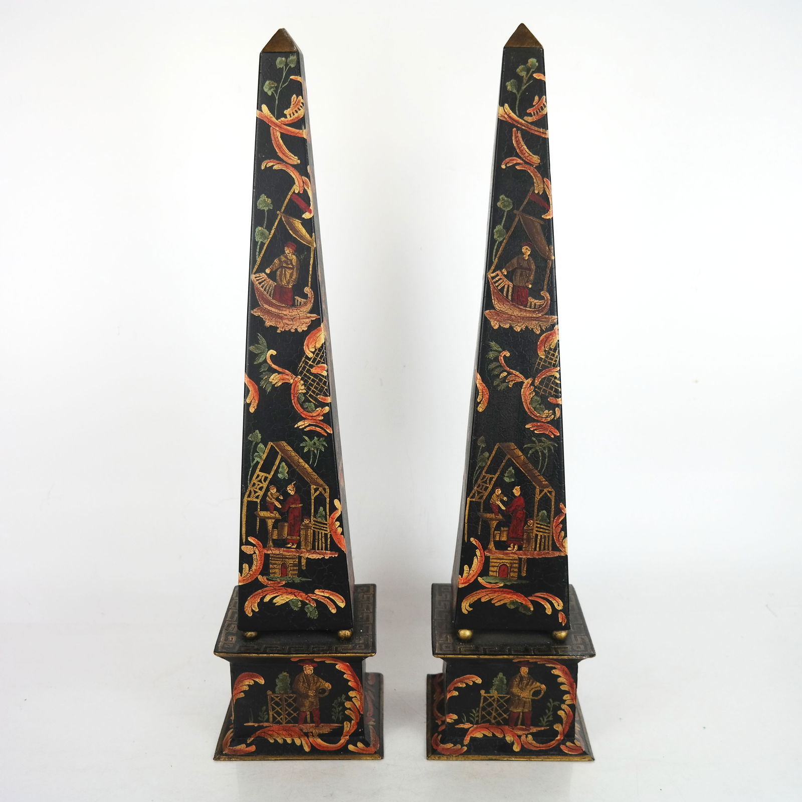 Pair of Chinoiserie Tole Obelisks: Pair of Chinoiserie tole obelisks, 20th century, overall with paint decoration on a black ground. [22" H x 5 1/4" W x 5 1/4" D]. Intentional crackled finish.