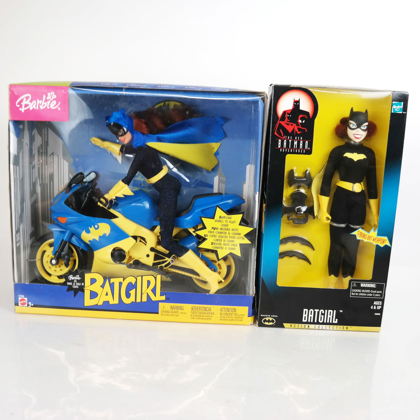 Barbie and Batgirl Dolls in Original Boxes: Mattel 2003 Barbie as Batgirl with motorcycle and Hasbro "The New Batman Adventures" Barbie doll, both in original boxes. [Larger: 13" H x 13 1/2" W x 4 1/2" D]. Marks, bruises and wear to boxes.