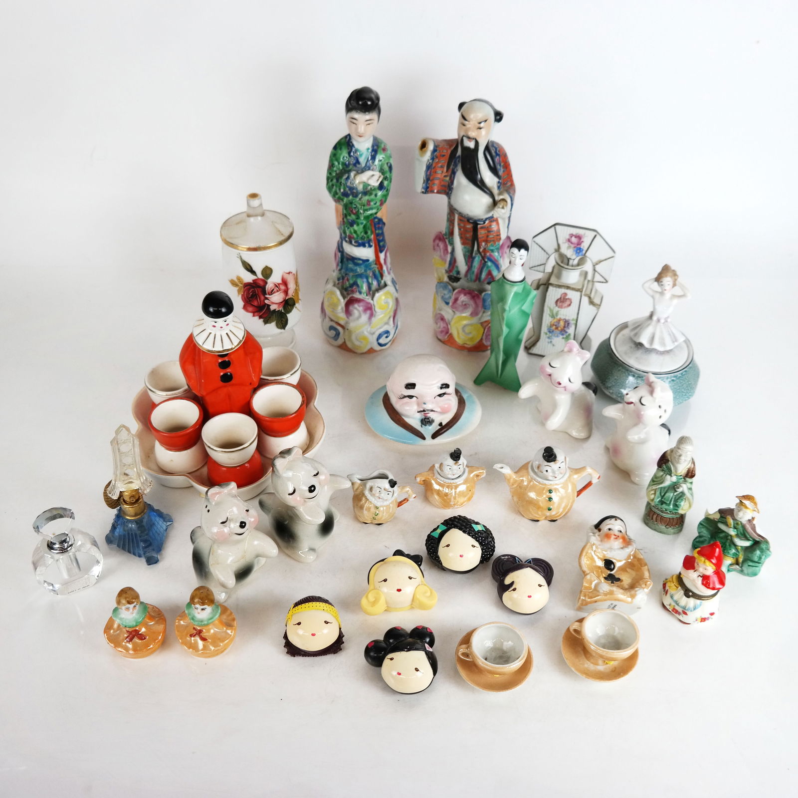 Assembled Group of Decorative Items: Assembled group of decorative items, including a figural egg cup stand, porcelain figures, perfume bottles, shakers and other items. [Tallest: 10 1/4' H x 3 1/4" Diam.]. Some with cracks, repairs, res