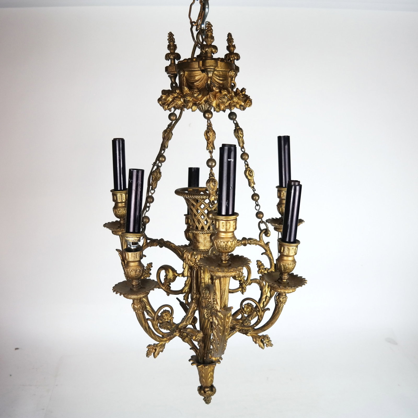 Louis XVI-Style Gilt Bronze Chandelier: Louis XVI-style gilt bronze chandelier, 20th century, with scrolling and foliate details. [26" H x 16" Diam.]. Areas of oxidation and wear.