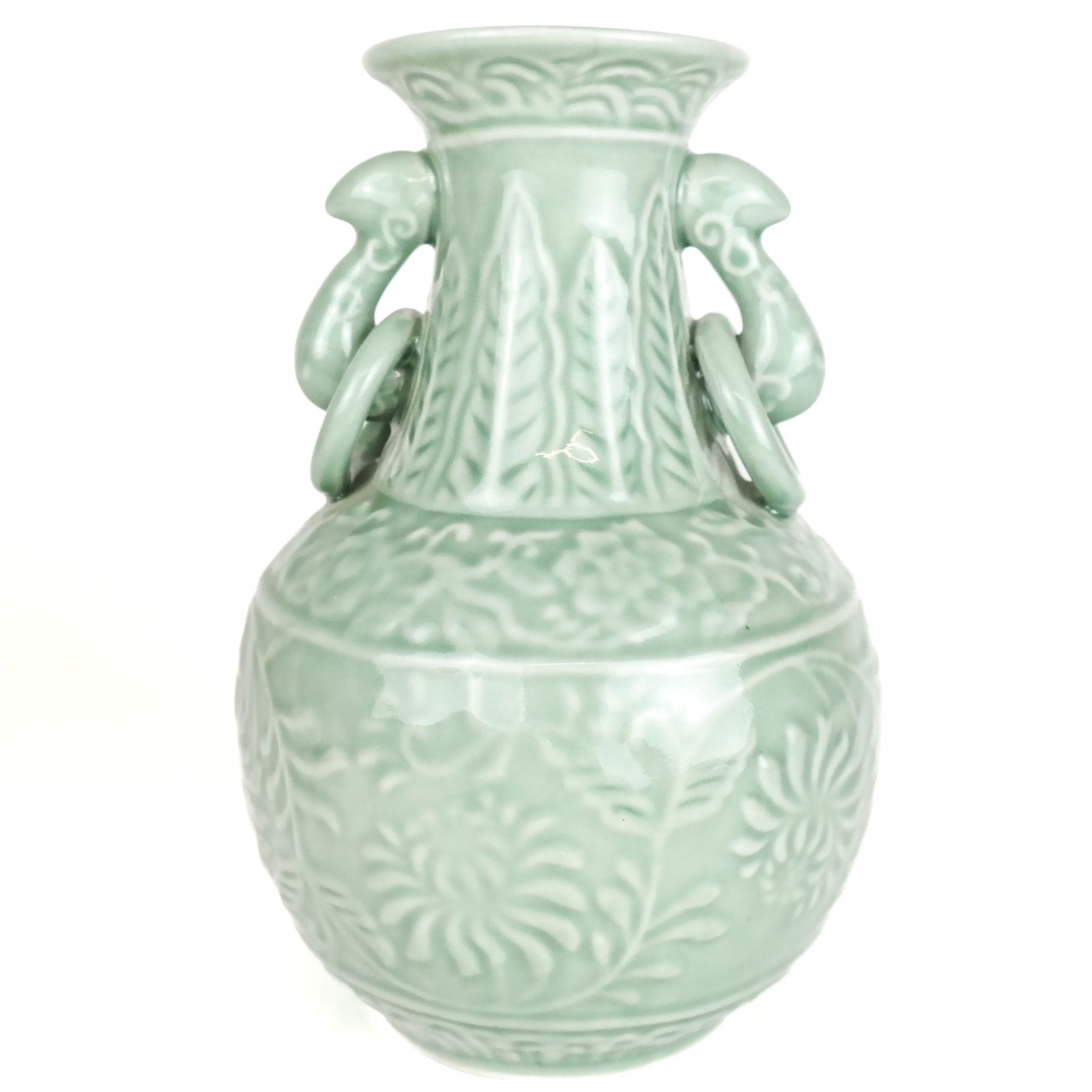 Asian Twin-Handled Celadon Vase: With acanthus and floral scroll decoration and rings to pierced handles. 20th century. [9 x 6 x 6 1/4 inches]. In good condition.