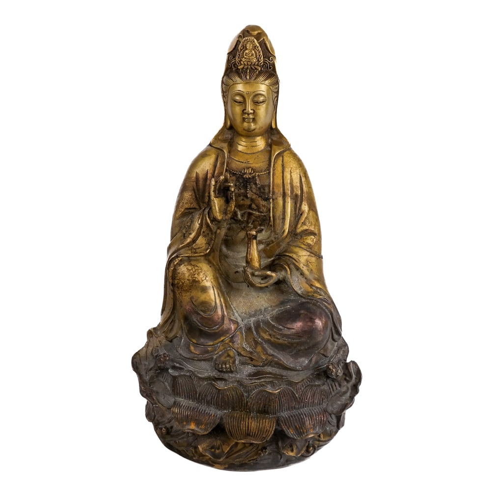Chinese Gilt Bronze Model of Guanyin: Also known as the Southeast Asian Bodhisattva Avalokitesvara, the Goddess of Compassion seated above a lotus leaf throne with bottle and hand in Shuni Mudra signifying "Patience and Compassion" with c