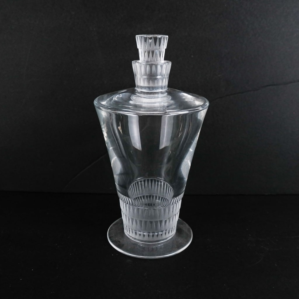 Lalique French Glass Decanter: Lalique French glass decanter in the Art Deco manner with frosted geometric bands, signed to base. [9 1/2" H x 5" Diam.]. Light scuffs to base and stopper.