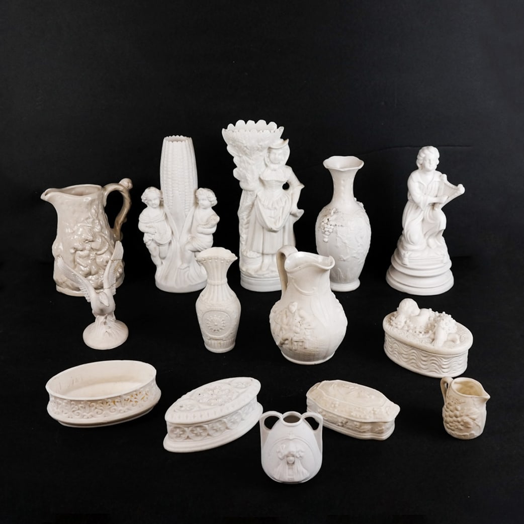 Group of Twelve (12) Parian Porcelain Articles: Group of twelve parian porcelain articles, including vases and other items with relief details, in the manner of Bennington. [Tallest: 9 1/4" H x 4" W x 2 1/2" D]. Some with breaks and restorations; h