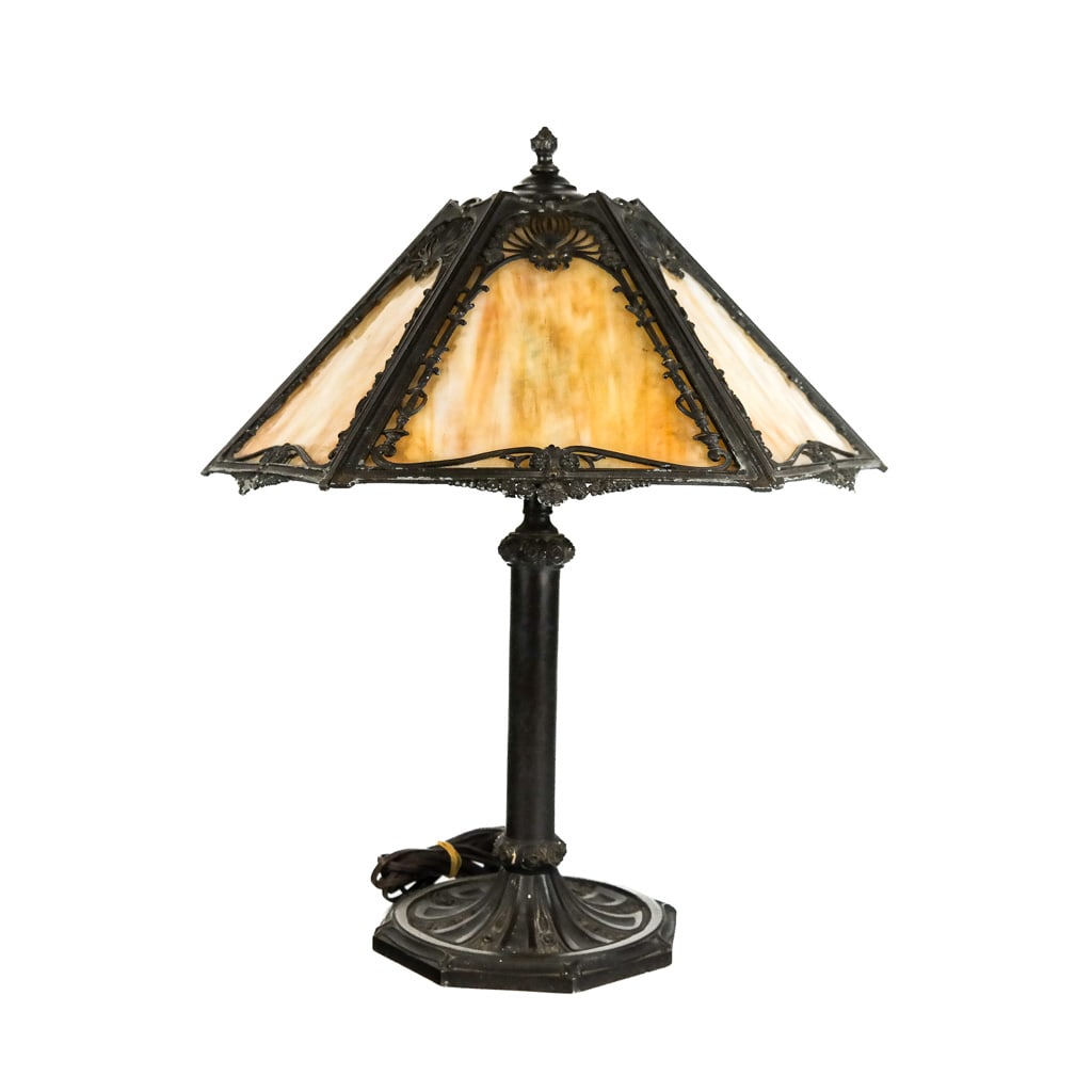 Antique Slag Glass Table Lamp: Antique slag glass table lamp, early 20th century, for parlor or boudoir, with metal overlay and rosette motif base, in the manner of Limbert or Bradley & Hubbard. [21" H x 17 1/2" Diam.]. Panes intac