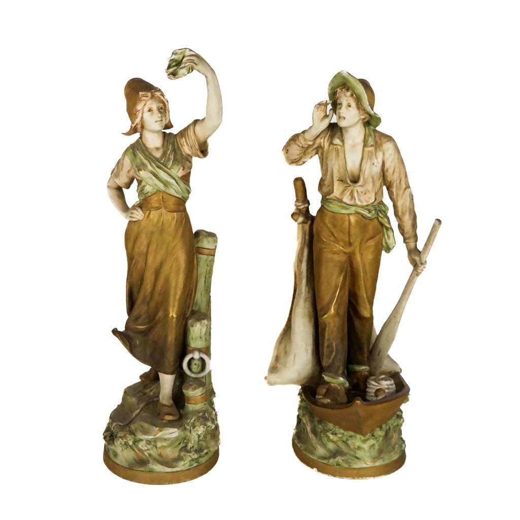 Pair of Royal Dux Porcelain Sculptures: Pair of Royal Dux porcelain sculptures of a man and a woman. [Larger: 20" H x 7" Diam. (base)].