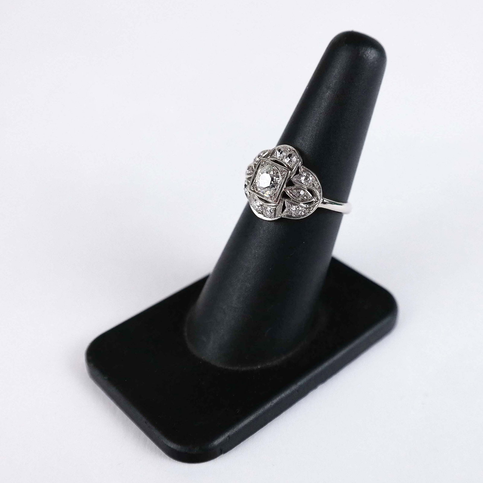 Platinum & Old Mine Cut Diamond Cocktail Ring: A platinum and diamond cocktail ring having a diamond melee surround with an old mine cut approximately .50 center stone. (1.8 dwt.).[Size 6] Provenance: Proceeds of the sale of this lot to benefit th