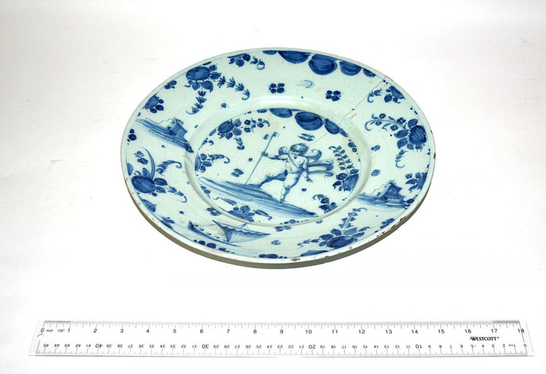 Antique Italian Charger: Antique Faience charger, light and deep blue, with cherub decoration in center decorated on border. Age cracks - repairs, 13 1/2" Dia.