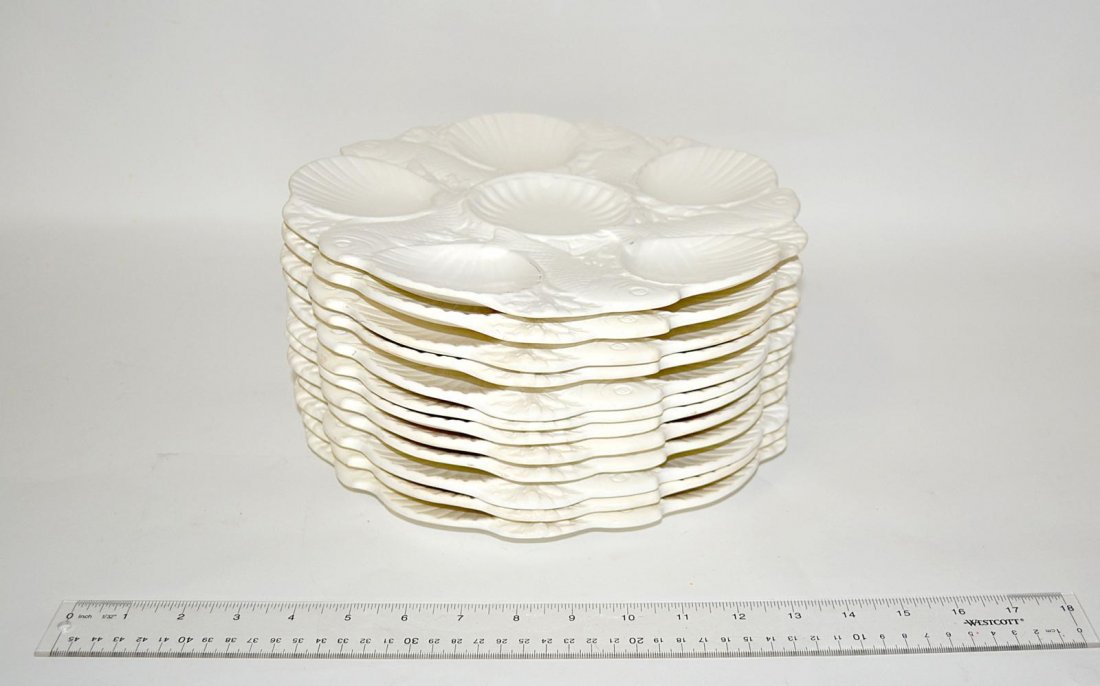 Set of 12 Minton Oyster Plates: 18th C. style salt glaze with fish decor. Each 10 5/8" Dia. In good condition.