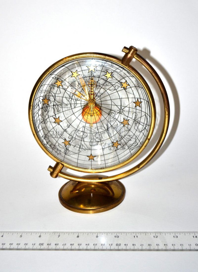 Art Deco Bronze & Glass Zodiac Clock: Double-sided glass clock with floating movement contained within a gold-finish bronze surround. In the manner of Gio Ponti. 8" W x 4" D x 8 3/4" H. Finish worn, otherwise in good condition.