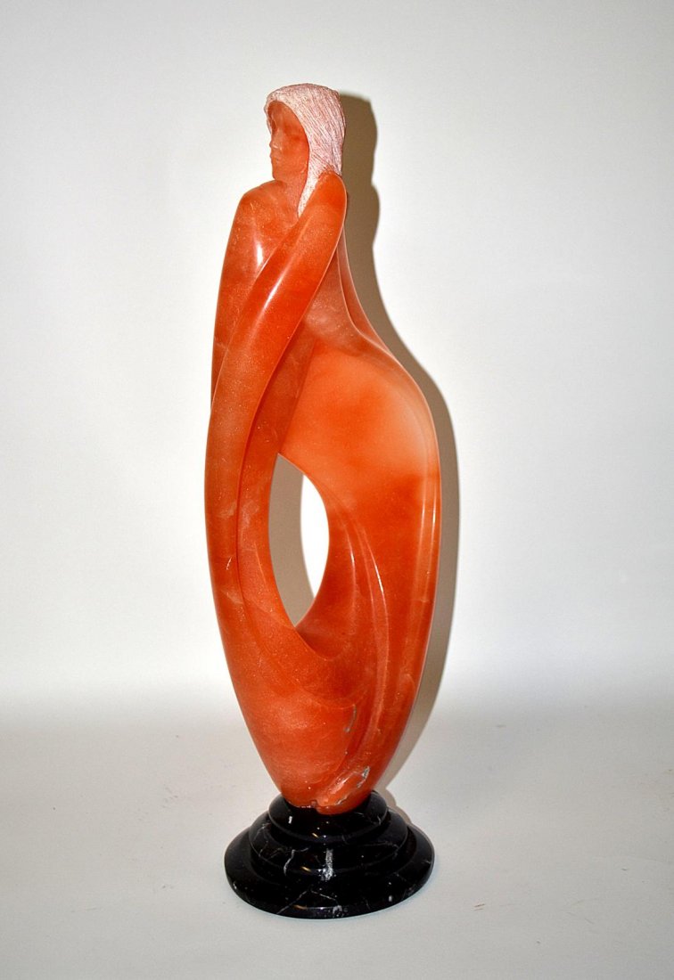 Jon De Collon 2004, Female Sculpture: Contemporary alabaster salmon-colored sculpture of a female on a black base. Good condition. 23" H x 9 1/2" Dia.