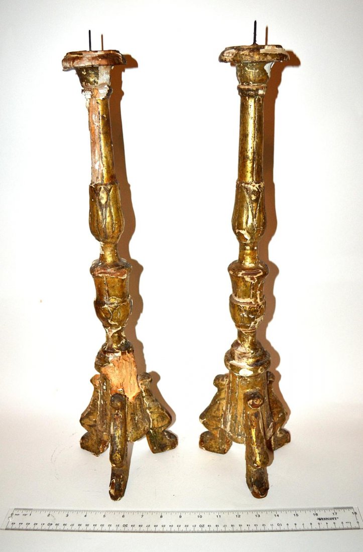 Pair of Carved Gilt Wood Candlesticks: A pair of Italian, 17th/18th C. carved gilt wood candlesticks. Fair condition. From the Estate of Arthur Laurents.