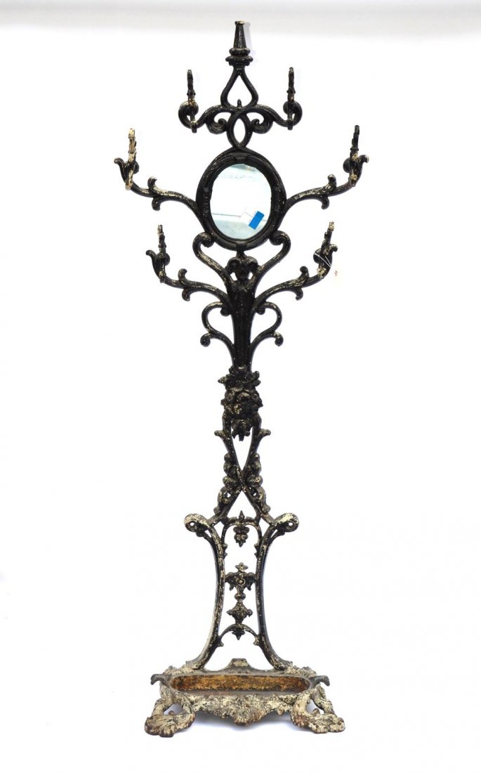 Victorian Iron Hall Tree: Having a round mirror at top and an umbrella liner. 45 1/2" H x 27" L.