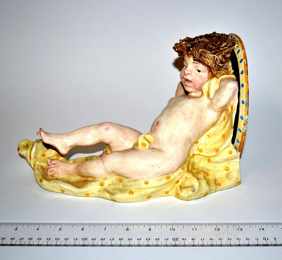 Italian Majolica Putti Wall Bracket: Bears some kiln imperfections, otherwise complete and in good condition. 11 1/4" x 6 1/2" x 7 1/4" D.